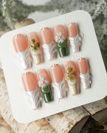 Duchess Olive nail close-up with olive green French styling and sculpted flower accents