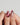 Glossy red nails with gold edge design