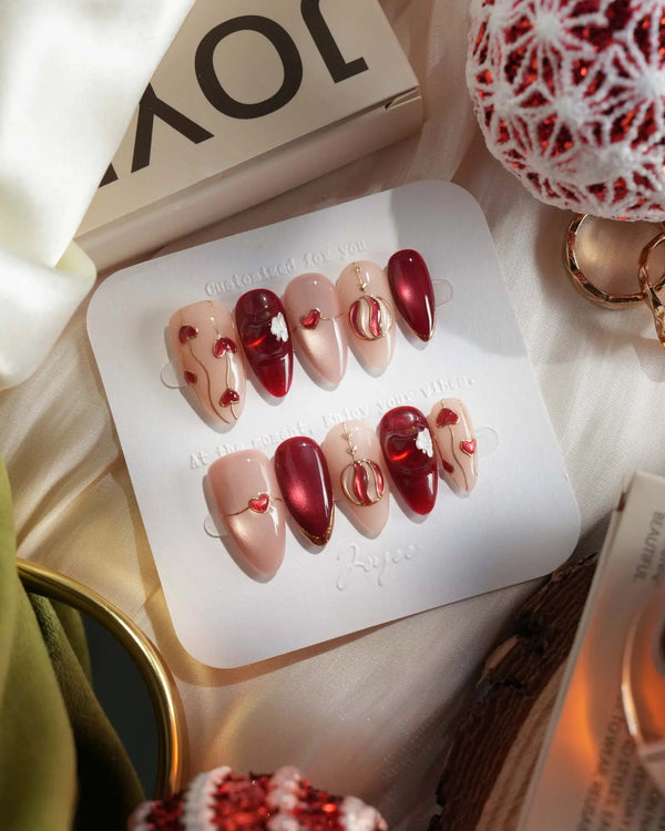 Glossy red holiday nails with 3D apple and festive sparkle