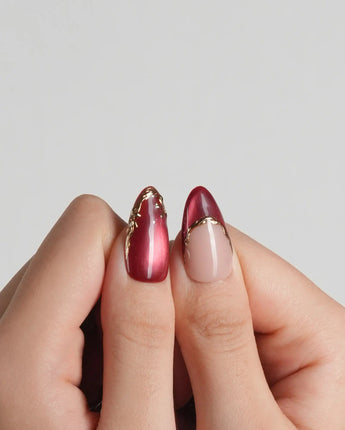 Lily Rouge press-on nails with glossy red cat-eye effect and raised floral accents