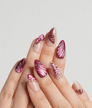 Velvet Flow press-on nails with berry red shimmer and sculpted metallic butterfly wing accents