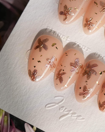 Glow Petals handmade press-on nails featuring Gentle Nude Pink, Rose Gold Flowers & Gold Flakes.