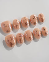 Glow Petals press-on nails in extra short oval shape — Gentle Nude Pink, Rose Gold Flowers & Gold Flakes.