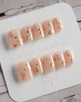 Glow Petals press-on nails in extra short square shape — Gentle Nude Pink, Rose Gold Flowers & Gold Flakes.