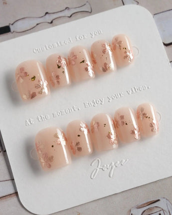Glow Petals press-on nails in extra short square shape — Gentle Nude Pink, Rose Gold Flowers & Gold Flakes.