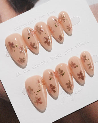 Glow Petals press-on nails in short almond shape — Gentle Nude Pink, Rose Gold Flowers & Gold Flakes.