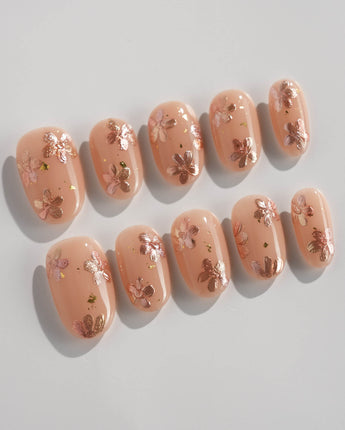 Glow Petals press-on nails in short oval shape — Gentle Nude Pink, Rose Gold Flowers & Gold Flakes.