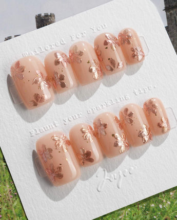 Glow Petals press-on nails in short square shape — Gentle Nude Pink, Rose Gold Flowers & Gold Flakes.