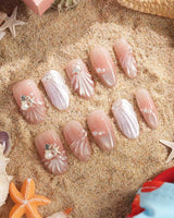 Glow Shore close-up of nude pink ocean nails with shell, starfish and pearl details