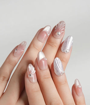 Glow Shore seaside nail set with pearly shell accents and soft silver shine
