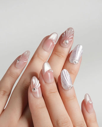 Glow Shore seaside nail set with pearly shell accents and soft silver shine