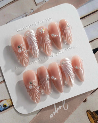 Glow Shore elegant ocean press-on nails with pearl accents and glossy gel finish