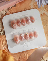 Glow Shore soft nude pink nails with dimensional shells and seaside sparkle
