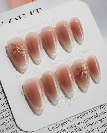 Glowing Blush press-on nails — Transparent Blush Cat Eye, Simple Silver Bow Outline. handmade nail art by Joyee Nails