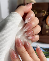 Glowing Blush handmade press-on nails featuring Transparent Blush Cat Eye, Simple Silver Bow Outline.