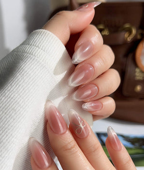 Glowing Blush handmade press-on nails featuring Transparent Blush Cat Eye, Simple Silver Bow Outline.