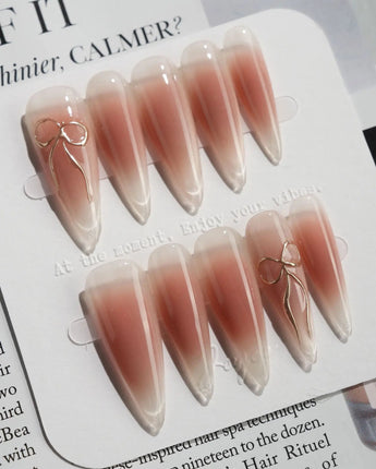 Glowing Blush press-on nails — Transparent Blush Cat Eye, Simple Silver Bow Outline. handmade nail art by Joyee Nails
