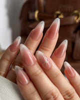 Glowing Blush nail art close-up showing Transparent Blush Cat Eye, Simple Silver Bow Outline. details
