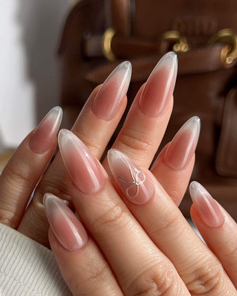Glowing Blush nail art close-up showing Transparent Blush Cat Eye, Simple Silver Bow Outline. details