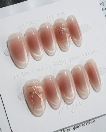 Glowing Blush press-on nails — Transparent Blush Cat Eye, Simple Silver Bow Outline. handmade nail art by Joyee Nails