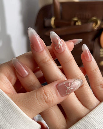 Glowing Blush press-on nails — Transparent Blush Cat Eye, Simple Silver Bow Outline. handmade nail art by Joyee Nails