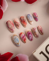 Baroque Palette nail art close-up showing marble mix design pink red blue swirl gold outline rose accents glossy details