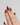 Gold-trimmed red nails with floral details