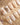 Beach-inspired gold and pearl nail art