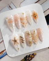 Golden Bay pearly white press-on nails with gold wire florals and 3D shells