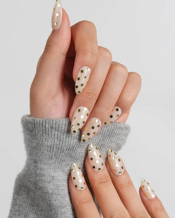 Golden Dot short almond press-on nails with gilded raindrop dots and cream shimmer