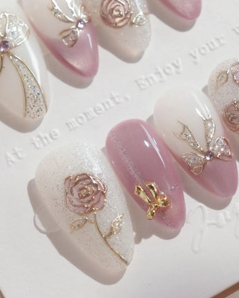 Golden Hour nail art close-up showing Romantic Dusty Pink Gradient, 3D Metallic Roses & Silver Ribbon. details
