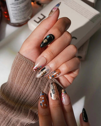 Golden Kiss handmade press-on nails with raised gold texture and patterned accent nails