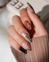 Golden Kiss M press-on nails in medium almond with amber, nude and black nail art