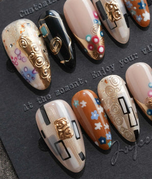 Golden Kiss S press-on nails in medium almond with Klimt-inspired gold patterning