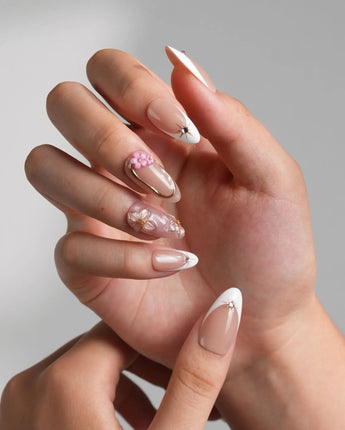 Golden Tide luxury nude nails with metallic gold outlines and delicate pearl accents