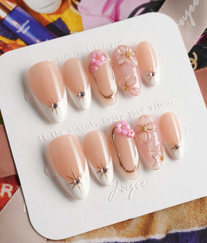 Golden Tide elegant press-on nails with pink and gold flowers on nude white French base