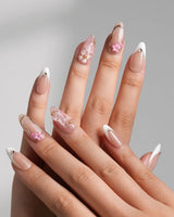 Golden Tide close-up of 3D floral accents, pearls, and gold French tip detailing
