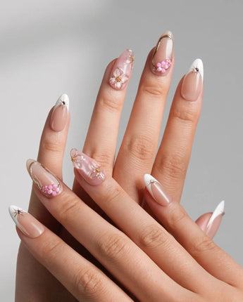 Golden Tide close-up of 3D floral accents, pearls, and gold French tip detailing