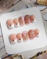 Golden Tide gold French tip floral press-on nails in extra short coffin shape