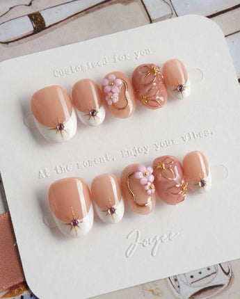 Golden Tide gold French tip floral press-on nails in extra short oval shape