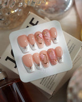 Golden Tide gold French tip floral press-on nails in medium coffin shape