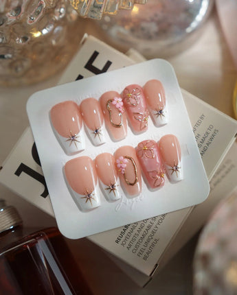Golden Tide gold French tip floral press-on nails in medium coffin shape