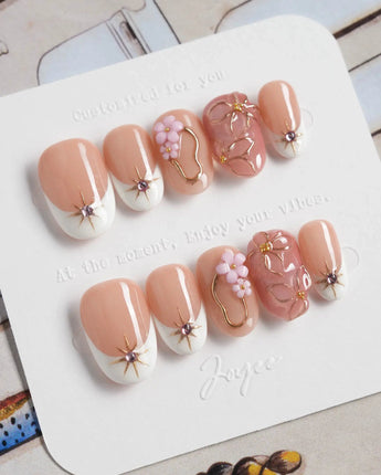 Golden Tide gold French tip floral press-on nails in short oval shape