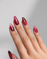 Gone with the Wind medium almond press-on nails with marbled burgundy and gold foil accents
