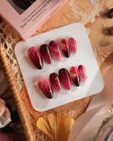 Gone with the Wind handmade press-on nails featuring Marbled Burgundy, Gold Foil Accents.