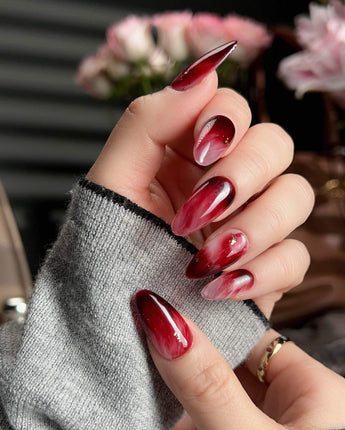 Gone with the Wind short almond press-on nails with burgundy marble and gold foil accents