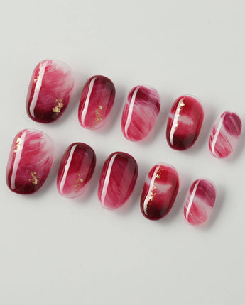 Gone with the Wind extra short oval press-on nails with burgundy marble and gold foil accents