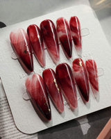 Gone with the Wind long stiletto press-on nails with burgundy marble and gold foil accents