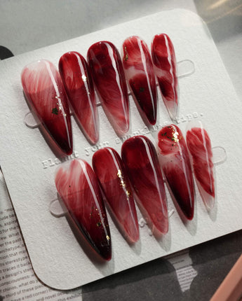 Gone with the Wind long stiletto press-on nails with burgundy marble and gold foil accents