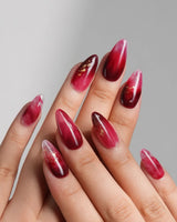 Gone with the Wind nail art close-up showing Marbled Burgundy, Gold Foil Accents. details